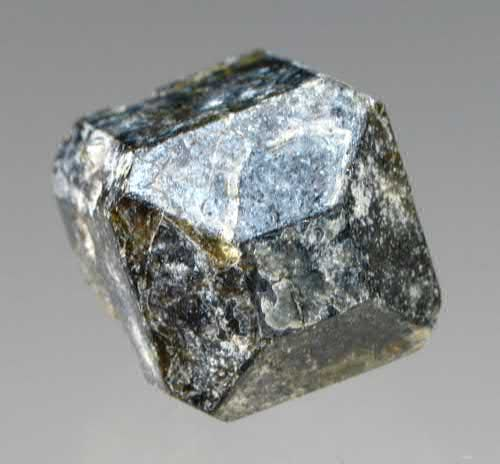 FIGURE 7. Wiluite, Ca19(Al,Mg)13(B,&,Al)5(Si2O7)4(SiO4)10(O,OH)10, partial crystal to 1.2 cm - rare member of the vesuvianite group.